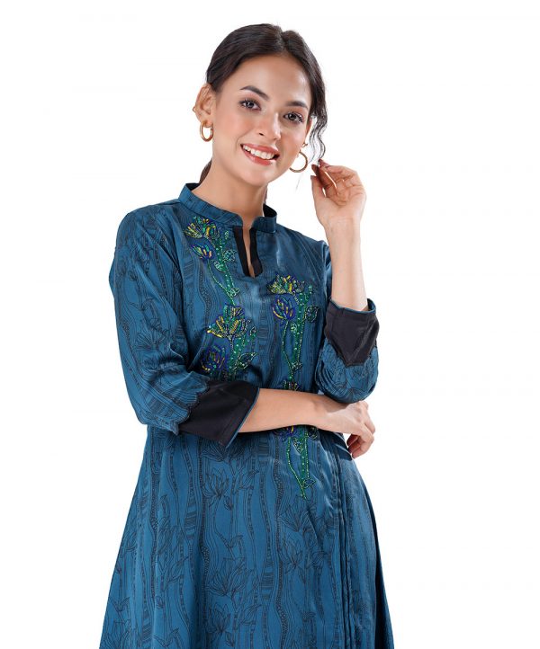 Blue all-over printed straight-cut Tunic in Crepe fabric. Designed with a band neck and three-quarter sleeves. Embellished with pin tucks and karchupi at the front.