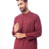 Maroon premium Panjabi in Cotton fabric. Designed with a mandarin collar and matching metal buttons on the placket. Embellished with karchupi at the top front.
