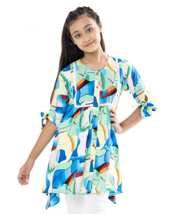 Multi-color A-line Tunic in printed Viscose fabric. Features a round neck with button-opening at the front. Three-quarter sleeves with stylish tie-knots on the cuffs. Embellished with lace attachment at the top front.