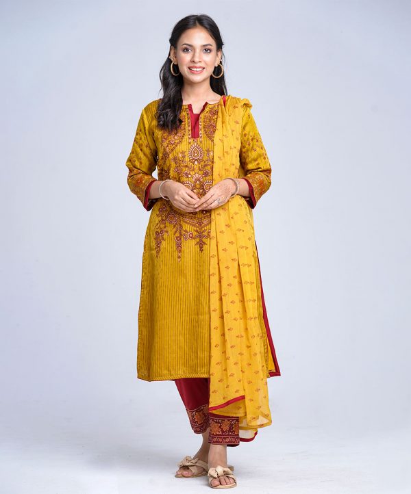Mustard all-over printed Salwar Kameez in textured Silk-blend and crepe fabric. The Kameez is designed with a round neck and three-quarter sleeves. Embellished with embroidery and karchupi at the front cuffs. Viscose lining in full body. Complemented by crepe culottes pants with printed border and printed chiffon dupatta.