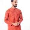 Brownish Red all-over printed semi-fitted Panjabi in Cotton fabric. Designed with a mandarin collar and hidden button placket. Embellished with embroidery on the chest.