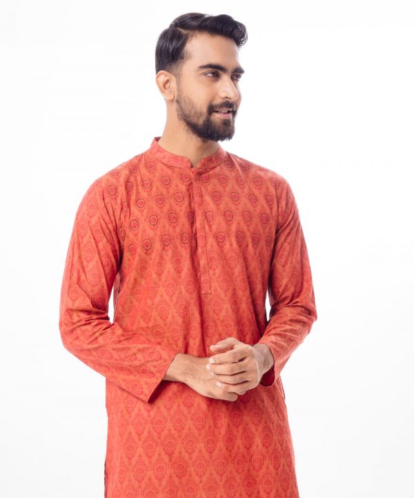 Brownish Red all-over printed semi-fitted Panjabi in Cotton fabric. Designed with a mandarin collar and hidden button placket. Embellished with embroidery on the chest.