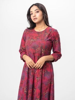 Maroon all-over printed patterned Gown in Georgette fabric. Designed with a round neck and three-quarter sleeves. Embellished with swing stitch at the top front. Single button opening at the back. Unlined.