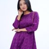 Purple all-over printed A-line Tunic in Crepe fabric. Designed with a low mock neck and three-quarter sleeves. Embellished with pin tucks at the top front and cuffs. Button opening at the back. Unlined.