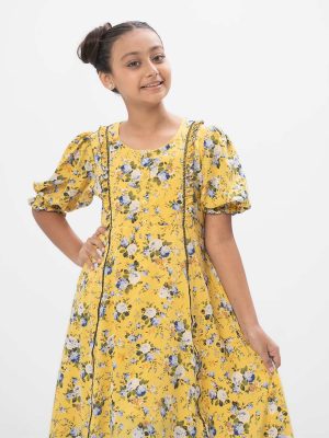 Yellow A-line frock in printed Georgette fabric. Features a round neck with buttons opening at the front and puff sleeves. Lace and frill detailing at the front. Viscose lining in full-body.