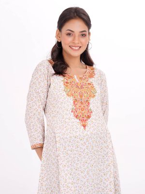 Mint Green A-line pattern Tunic in printed Georgette fabric. Designed with a round neck and three-quarter sleeves. Embellished with embroidery at the top front. Printed patch attachment at the cuffs and hemline. Single button opening at the back. Unlined.