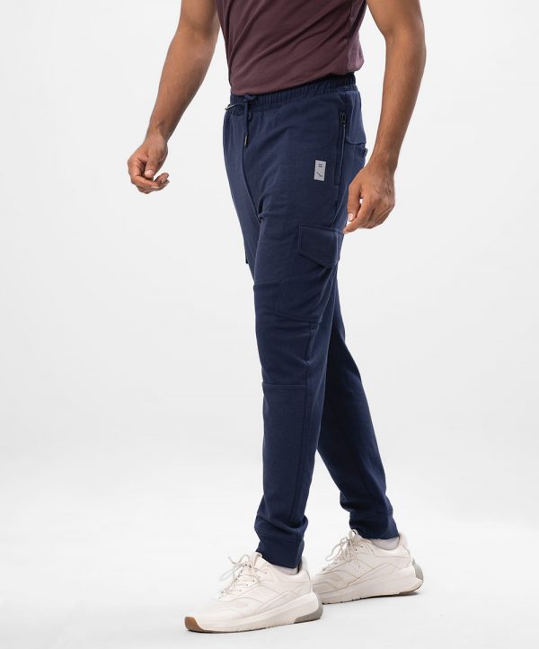 Navy Blue Trousers in interlock Cotton blend fabric. Designed with elasticized waistband with adjustable drawstring and side pockets with zipper. Leg pockets with flap.