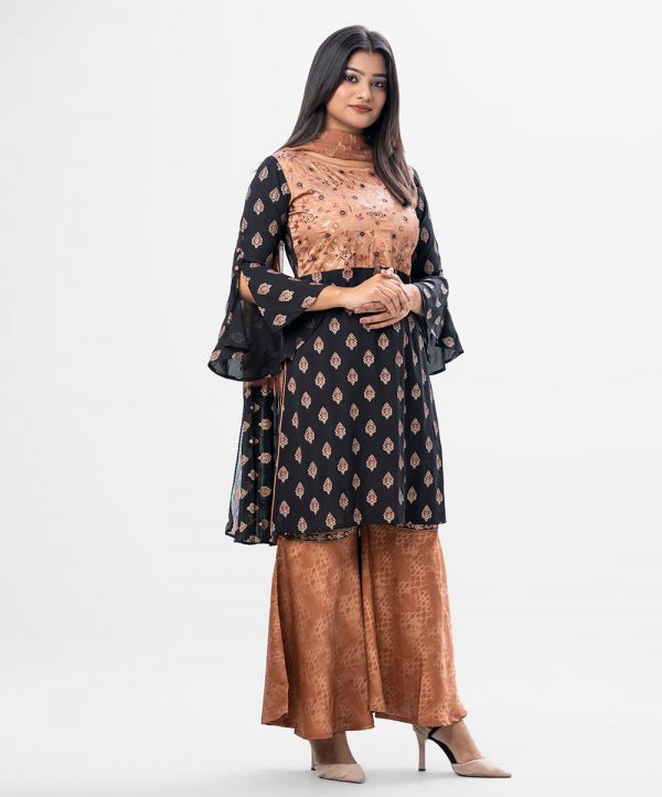 Short style printed georgette Sharara Kameez. Round neckline, flounce sleeved, karchupi beads with mirror work. Chiffon dupatta with crepe sharara.