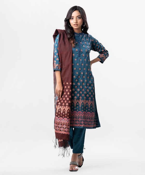 Sea Green all-over printed Salwar Kameez in Crepe fabric. The Kameez features a band neck with hook closure at the front and three-quarter sleeves. Embellished with karchupi at the top front. Complemented by culottes pants and a printed half-silk dupatta.