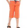 Coral orange all-over printed three-quarter pants in twill Cotton fabric. Five pockets, Covered elastic with adjustable drawstring at hemline & zipper fly.
