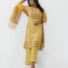 Yellow all-over printed Salwar Kameez in Viscose fabric. The Kameez is designed with a low mock neck and three-quarter sleeves. Embellished with embroidery at the top front. Button opening at the back. Complemented by palazzo pants and a half-silk dupatta.