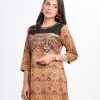 Brown all-over printed A-line Kameez in Crepe fabric. Designed with a low mock neck and three-quarter sleeves. Sequined net details and karchupi at the top front. Printed patch attachment at the cuffs. Single button opening at back.