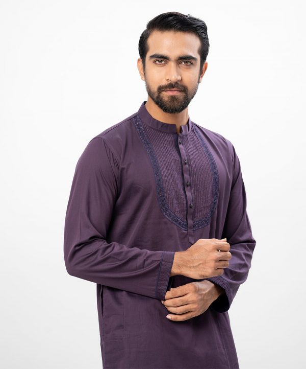 Purple premium Panjabi in Cotton fabric. Designed with a mandarin collar and matching metal buttons on the placket. Embellished with karchupi at the top front.