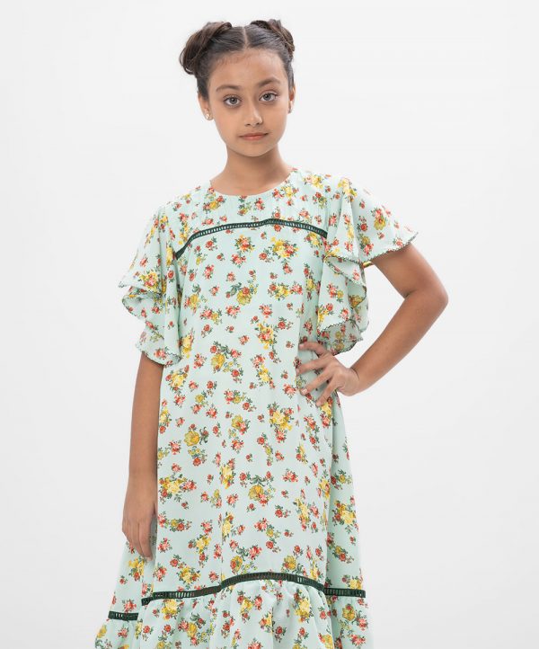Mint Green A-line Frock in printed Georgette fabric. Designed with a round neck and butterfly sleeves. Detailed with lace and pin tucks at the top front. Viscose lining in half body. Buttoned opening at the back.