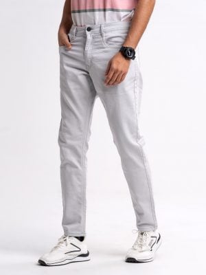 Gray slim fitted jeans in cotton spandex denim fabric. Five pockets, button fastening on the front and zipper fly.