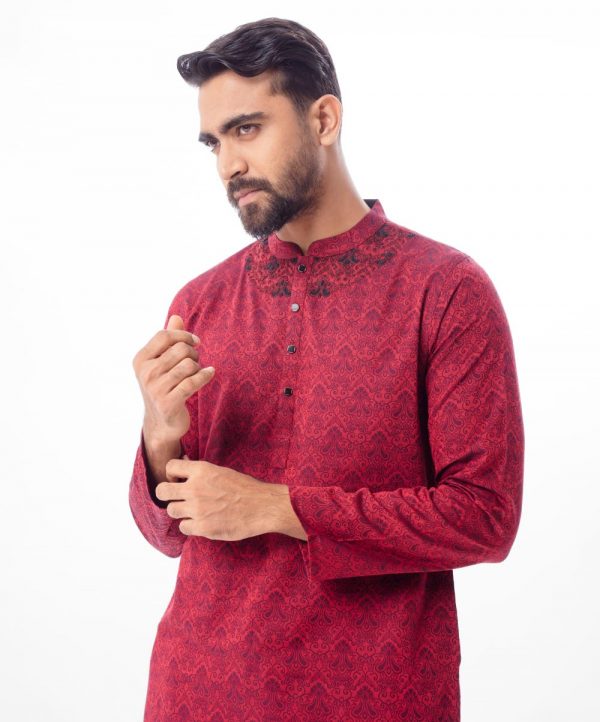 Maroon fitted Panjabi in Jacquard Cotton fabric. Designed with a mandarin collar and matching metal buttons on the placket. Embellished with karchupi at the top front.