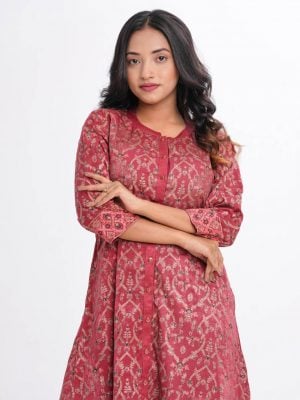 Garnet pink all-over printed A-line long Tunic in Velvet finish Georgette fabric. Features a low mock neck with a front button opening and three-quarter sleeves. Embellished with karchupi at the front and cuffs. Unlined.