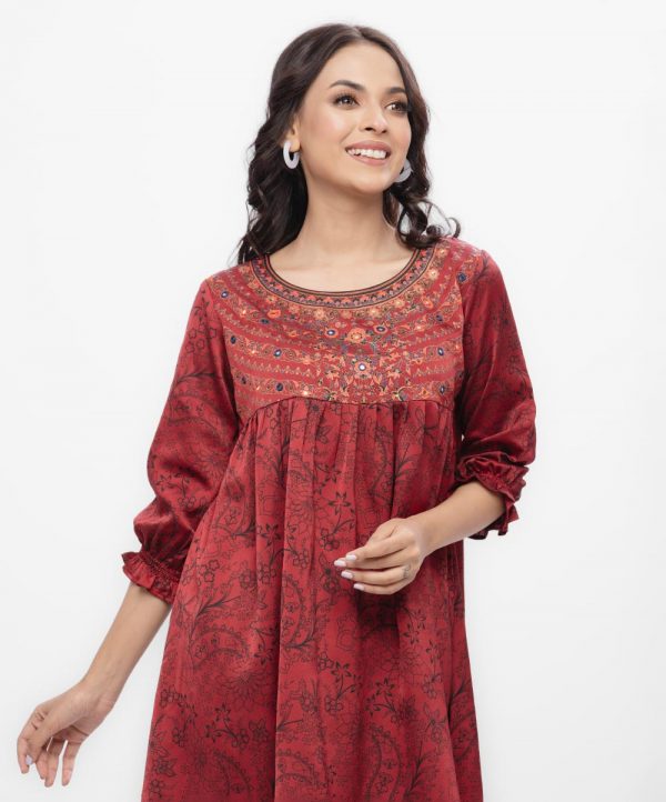 Maroon all-over printed woven top in Crepe fabric. Designed with a round neck and bishop sleeves. Embellished with karchupi and pleats at the front. Single button opening at the back. Unlined.