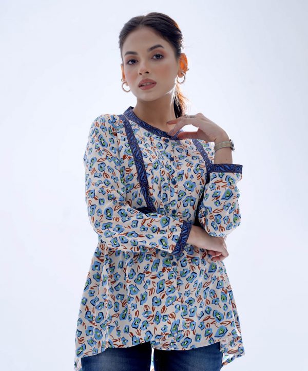 Ivory A-line Tunic in printed Georgette fabric. Features a band neck with button opening at the front and long sleeves. Designed with pin tucks at the front and gathers from the waistline. Printed patch attachment at the front and cuffs. Unlined.