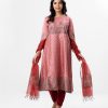 Patterned salwar kameez in viscose fabric. Three quater sleeved, round neckline and karchupi with beads. Muslin dupatta with crepe pant-style pajamas.