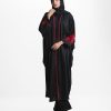 Women's long abaya in design georgette fabric. High neck with zoom fabric patch and lace work at the front. Rose cutwork in velvet fabric at sleeves.