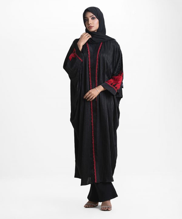 Women's long abaya in design georgette fabric. High neck with zoom fabric patch and lace work at the front. Rose cutwork in velvet fabric at sleeves.