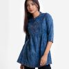 Women's A-line tunic in denim fabric. Band collar, three-quarter sleeves. Embroidery at front.