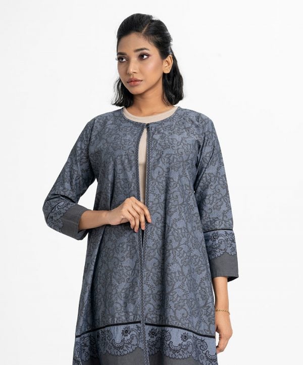 Women's floral printed long shrug in chambray fabric. Single button front opening with round neck, full sleeves.