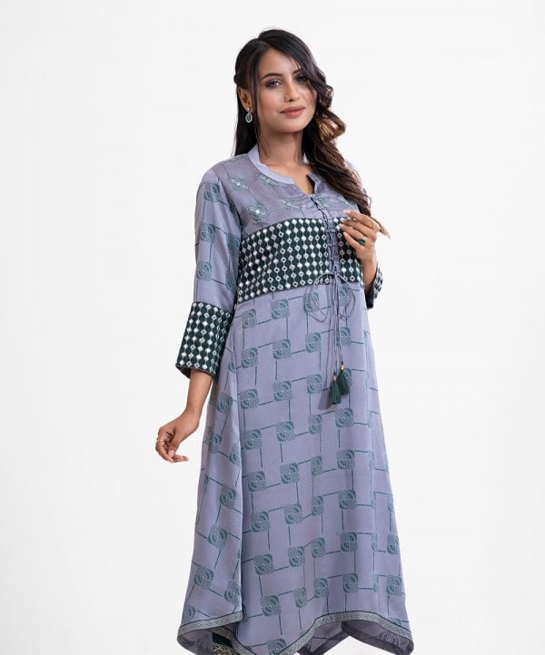 Printed elongated hem kameez in crepe fabric. Band neck with tassel tie placket. Karchupi at front and sleeves.