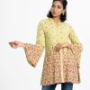 Women's floral printed shirt-style tunic in viscose fabric. Mandarin collar with V cut buttons placket, full bell sleeves.
