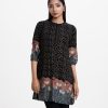 Women's printed A-line tunic in viscose fabric. Band collar with placket, three-quarter sleeves. Embroidery at sleeves and front.