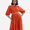 Printed maxi dress with smokes in viscose fabric. Boat neck with puff sleeves. Karchupi detailed belt on the waistline.