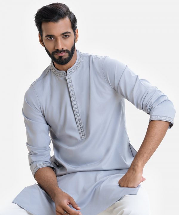 Men's fitted panjabi in blended cotton fabric. Embroidery and karchupi at front with hidden button placket.