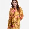 Women's long pattern flared Maxi in printed georgette fabric. Round neck with tassel ties, three-quarter sleeves. Smokey gathered waistline and patch at hem.