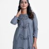Women's high-low hem kameez in chambray fabric. Boat neck, full-sleeved. Big flower and leaf design embroidery at the front and backside. Inseam pockets.
