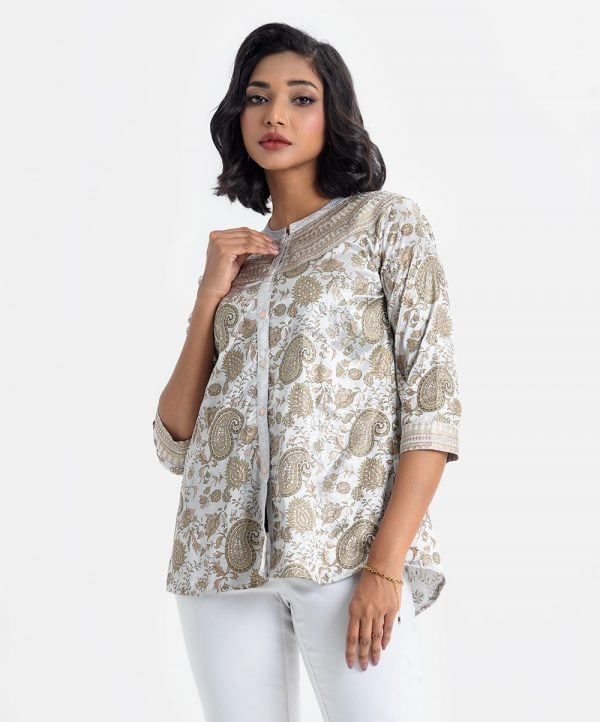 All-over printed shirt style tunic in art silk fabric. Stand collar and three-quarter sleeves. Embroidery at the front.