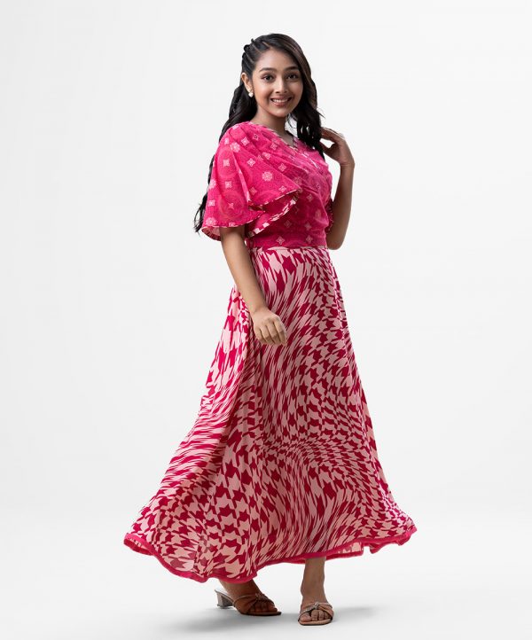 Teen girl's printed skirt top set in georgette fabric. Retro wrap style top with butterfly sleeves and karchupi at front. Elasticated waistline skirt with hidden side zipper.