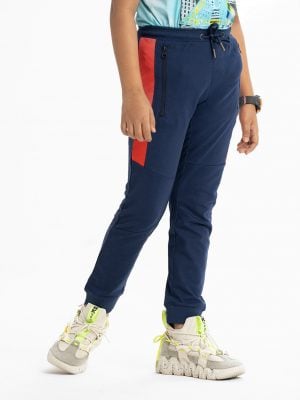 Kid boys slim fitted track pant in french terry fabric. Concealed elasticated waistline with drawstring cord. Two side pockets and a back pocket.