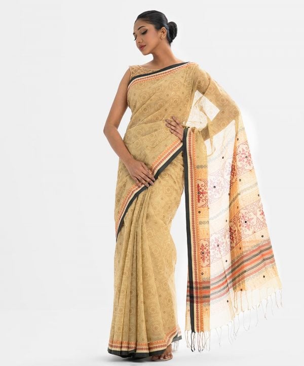 All-over printed Saree in Cotton fabric. Embellished with embroidery, and fringe trim at the border of Aanchal.