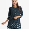 Women's shirt style tunic in polka printed georgette fabric. Round neck and three-quarter sleeves and front buttons opening.