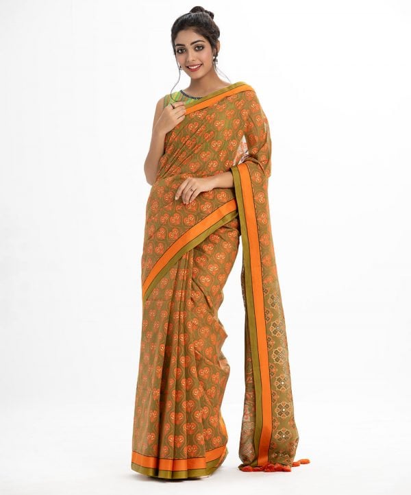 All-over printed Saree in Cotton fabric. Embellished with embroidery, and fringe trim at the border.