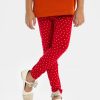 Kid girl's leggings in stretchable cotton knit fabric. Concealed elasticated waistline and all over heart printed.