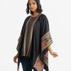 Women's abaya style cape in crepe fabric. Round neck, print detail and elongated hem with attached beads.