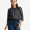 Printed balloon tops in georgette fabric. Round neck with pleats, three-quarter sleeved, elasticated at the hemline.