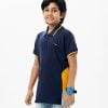 Kid boy polo shirt in cotton pique fabric. Classic collar with button placket and short sleeves.