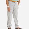 Kid boys slim fitted track pant in french terry fabric. Concealed elasticated waistline with drawstring cord. Two side pockets and a back pocket.