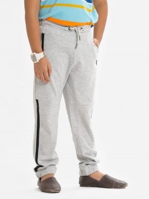 Kid boys slim fitted track pant in french terry fabric. Concealed elasticated waistline with drawstring cord. Two side pockets and a back pocket.