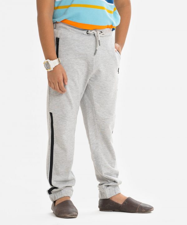 Kid boys slim fitted track pant in french terry fabric. Concealed elasticated waistline with drawstring cord. Two side pockets and a back pocket.