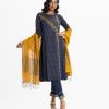 Women's printed salwar kameez in crepe fabric. Boat neck, full sleeves with katan fabric patch at hem and karchupi at front of kameez. Half-silk dupatta with viscose culottes pants.
