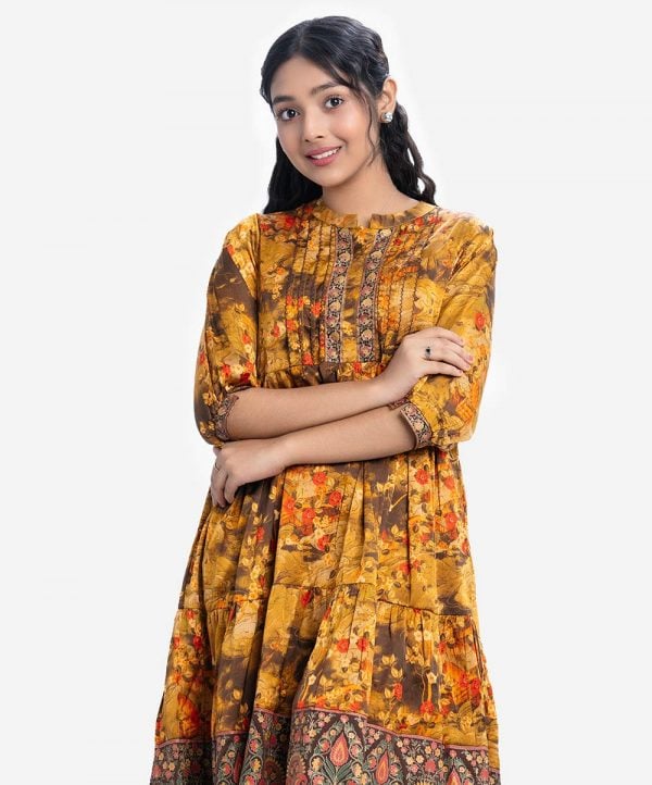 Teen girl's frock style tunic in printed georgette fabric. Stand collar and three-quarter sleeves. Patch at placket, sleeves cuff and hem.